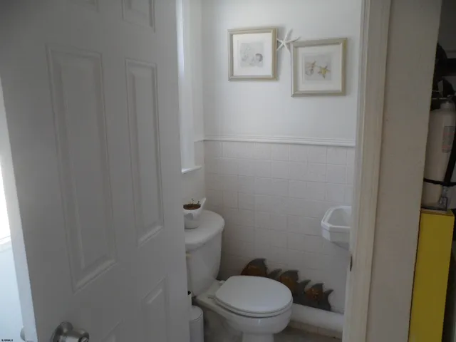 a white toilet sitting next to a bathroom sink