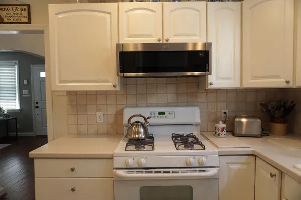 a kitchen with a sink a stove and cabinets