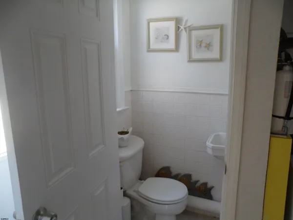 a white toilet sitting next to a small bathroom