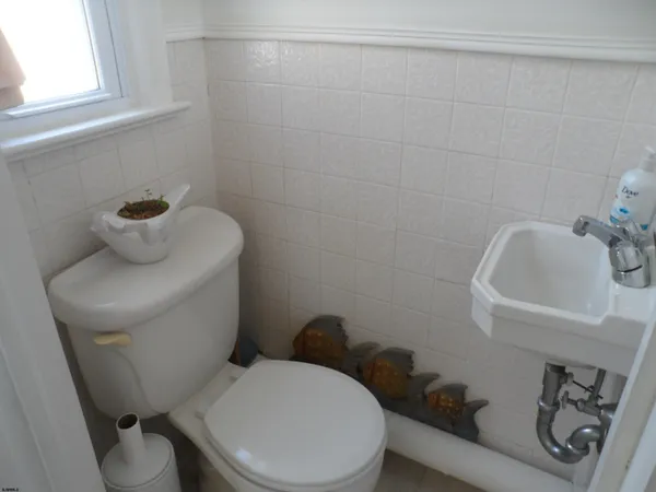a white toilet sitting next to a bathroom sink