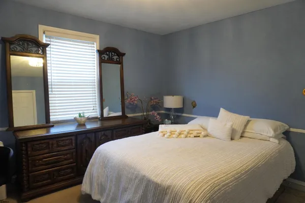 a bedroom with a bed and a dresser