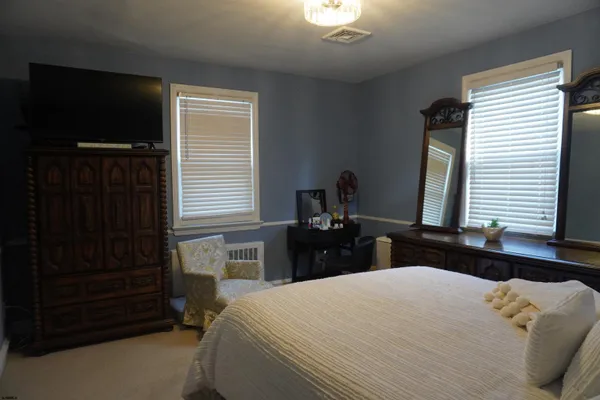 a bedroom with a bed and a dresser