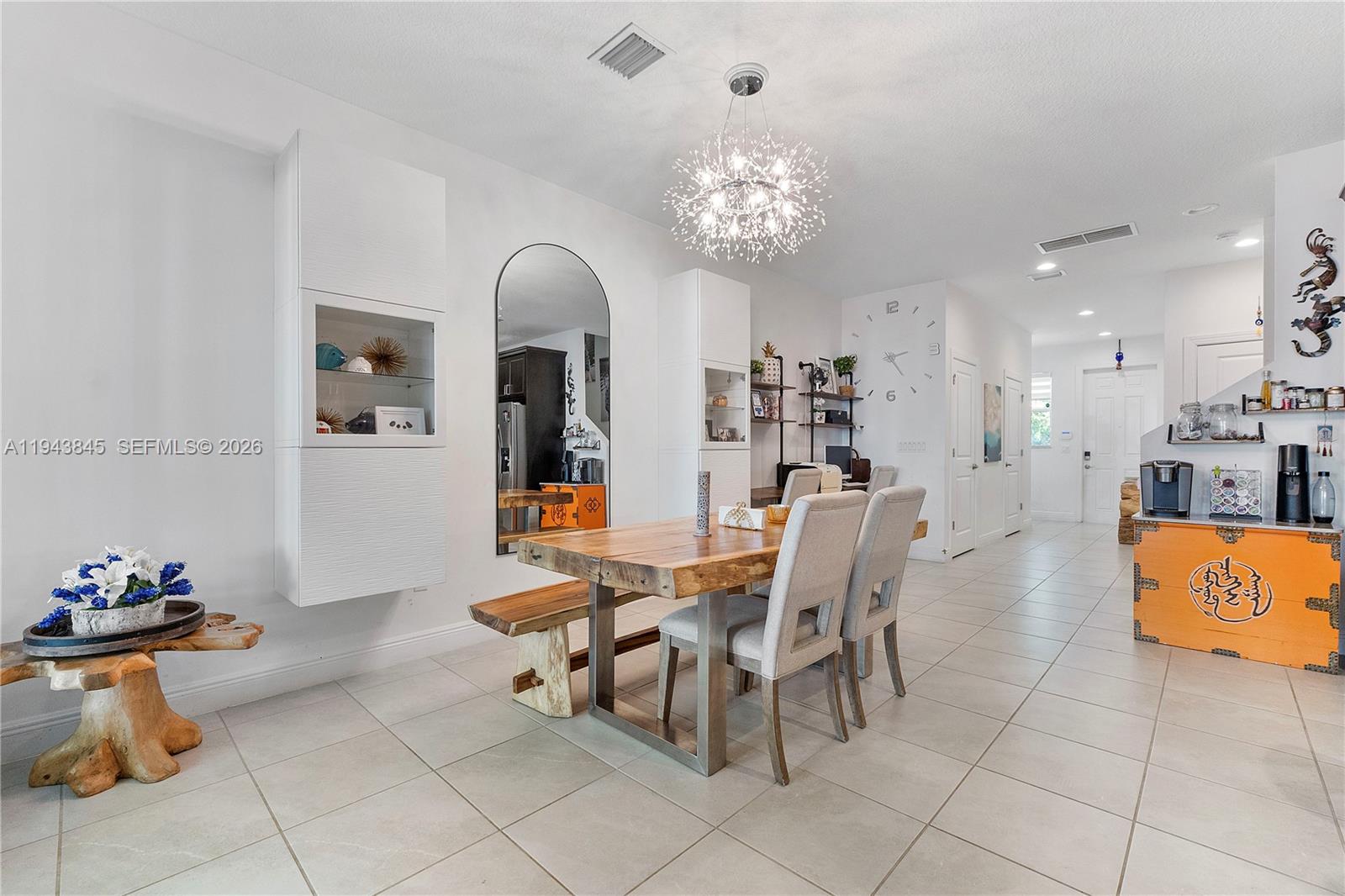 1827 Sandpiper Pointe Place Deerfield Beach, FL 33442 - Photo 11 of 48 a view of a dining room and kitchen with furniture and a large window