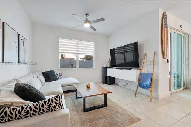 a kitchen with stainless steel appliances granite countertop a refrigerator a stove a sink a dining table and chairs