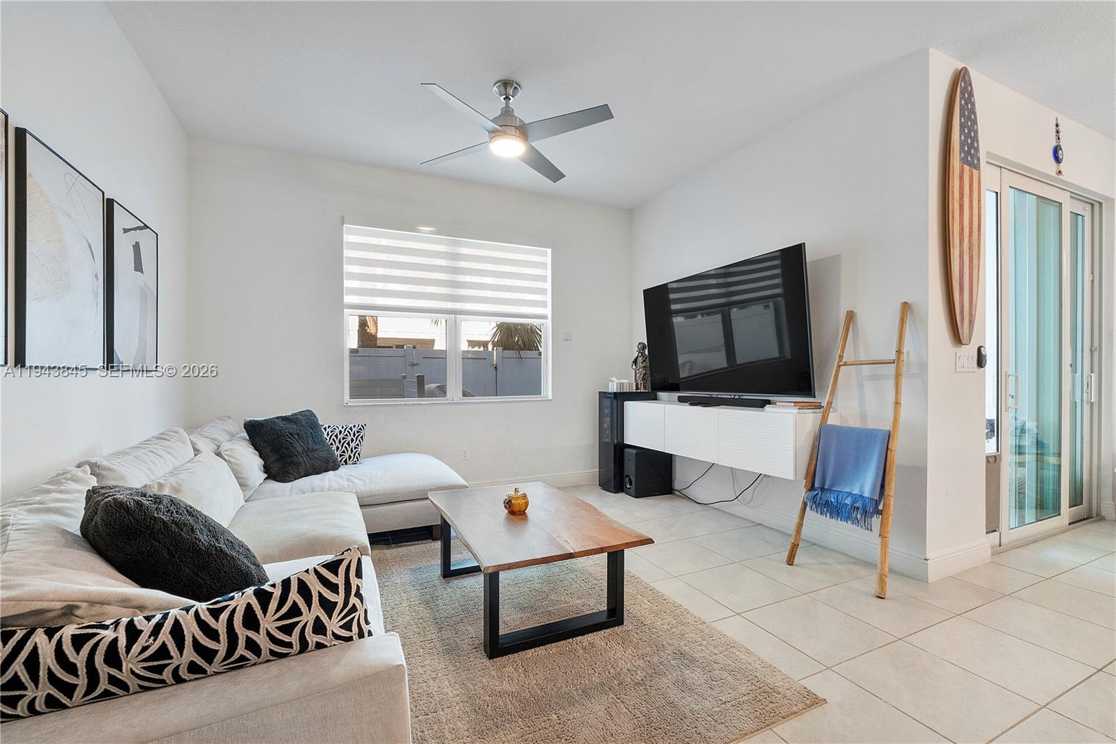1827 Sandpiper Pointe Place Deerfield Beach, FL 33442 - Photo 13 of 48 a living room with furniture and a flat screen tv