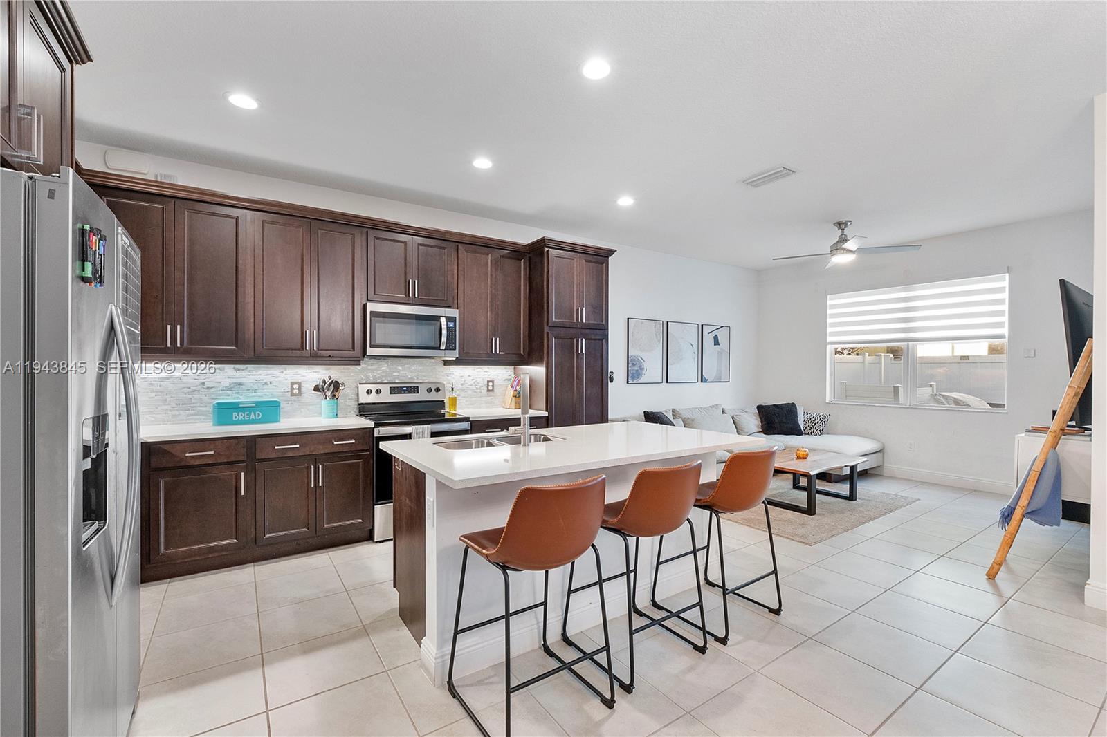 1827 Sandpiper Pointe Place Deerfield Beach, FL 33442 - Photo 15 of 48 a kitchen with stainless steel appliances granite countertop a refrigerator and a stove top oven