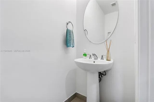 a view of a workspace with furniture and a flat screen tv