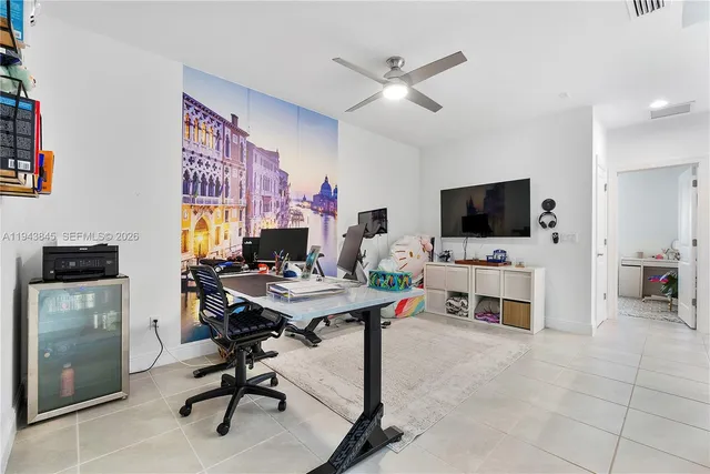 a bedroom with a large bed and a potted plant