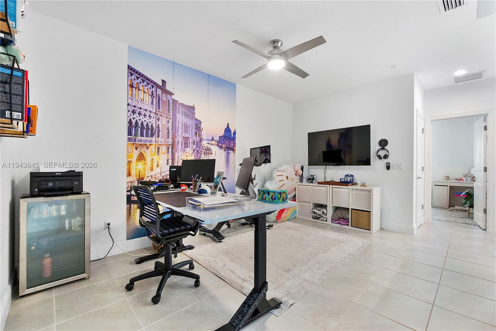 1827 Sandpiper Pointe Place Deerfield Beach, FL 33442 - Photo 22 of 48 a view of a workspace with furniture and a flat screen tv