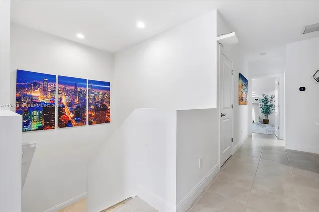 a bedroom with a bed a rug and painting on the wall