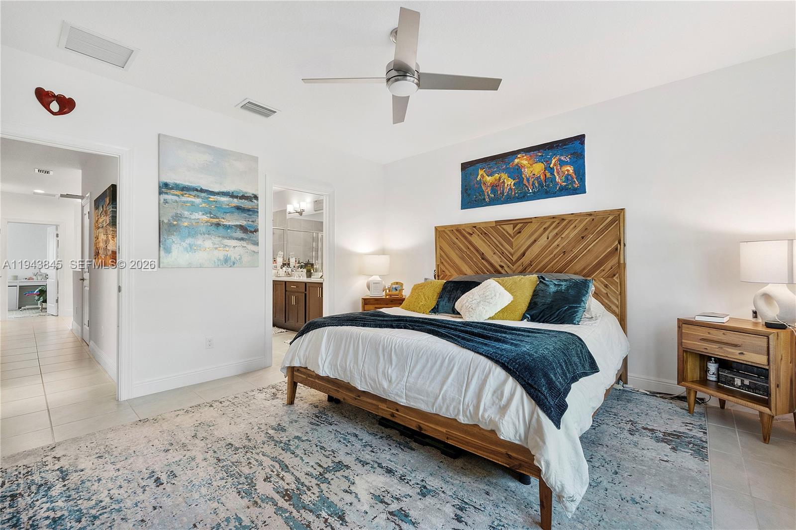 1827 Sandpiper Pointe Place Deerfield Beach, FL 33442 - Photo 25 of 48 a bedroom with a bed a rug and painting on the wall