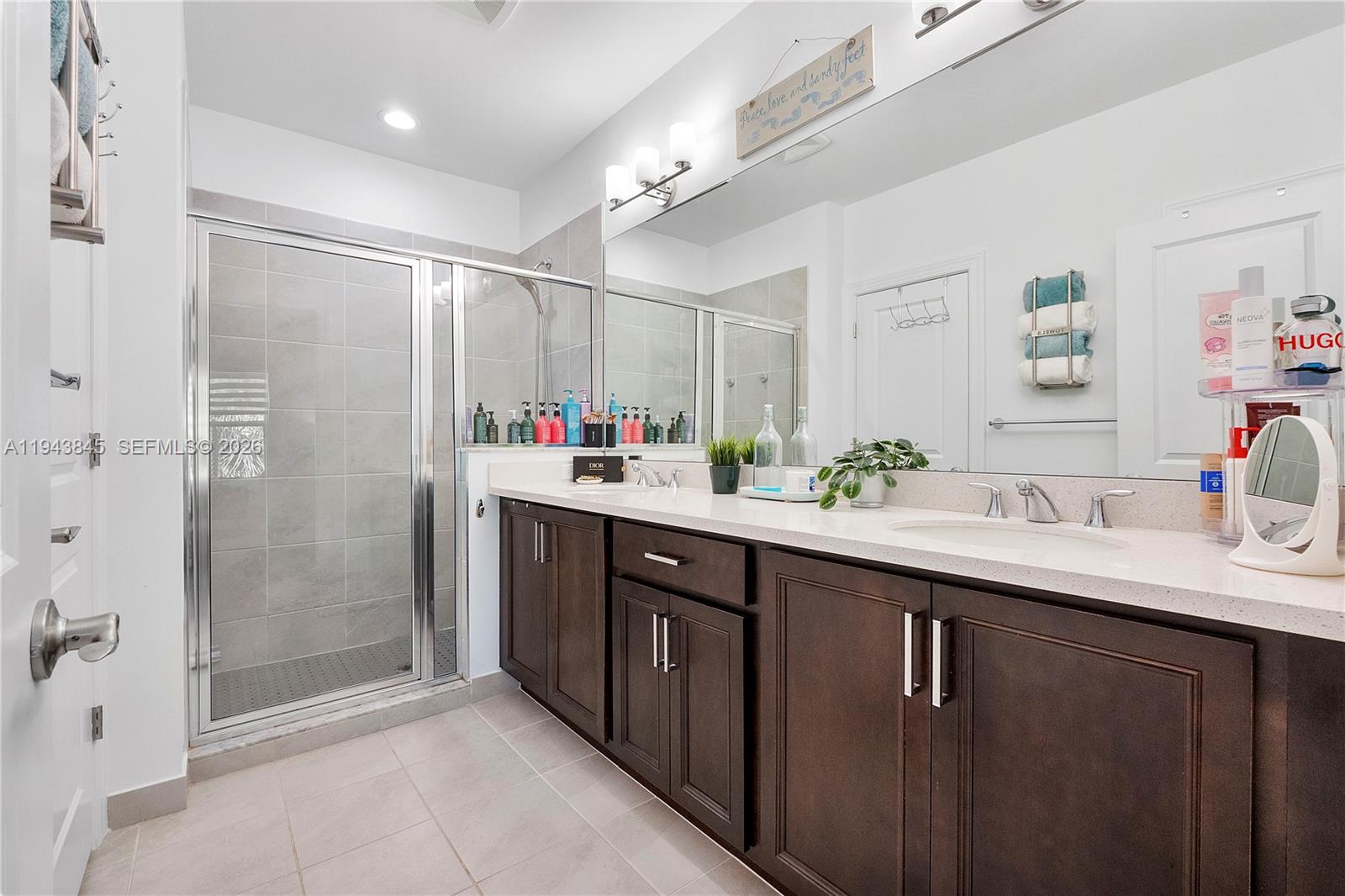 1827 Sandpiper Pointe Place Deerfield Beach, FL 33442 - Photo 27 of 48 a bathroom with a sink double vanity and a shower