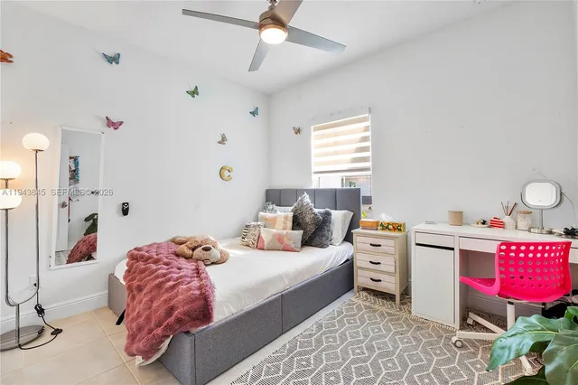 a bedroom with a bed a dresser and a book shelf