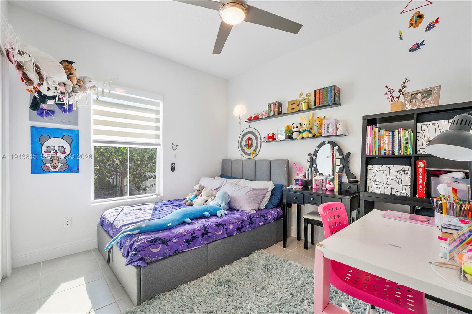 1827 Sandpiper Pointe Place Deerfield Beach, FL 33442 - Photo 30 of 48 a bedroom with a bed a dresser and a book shelf