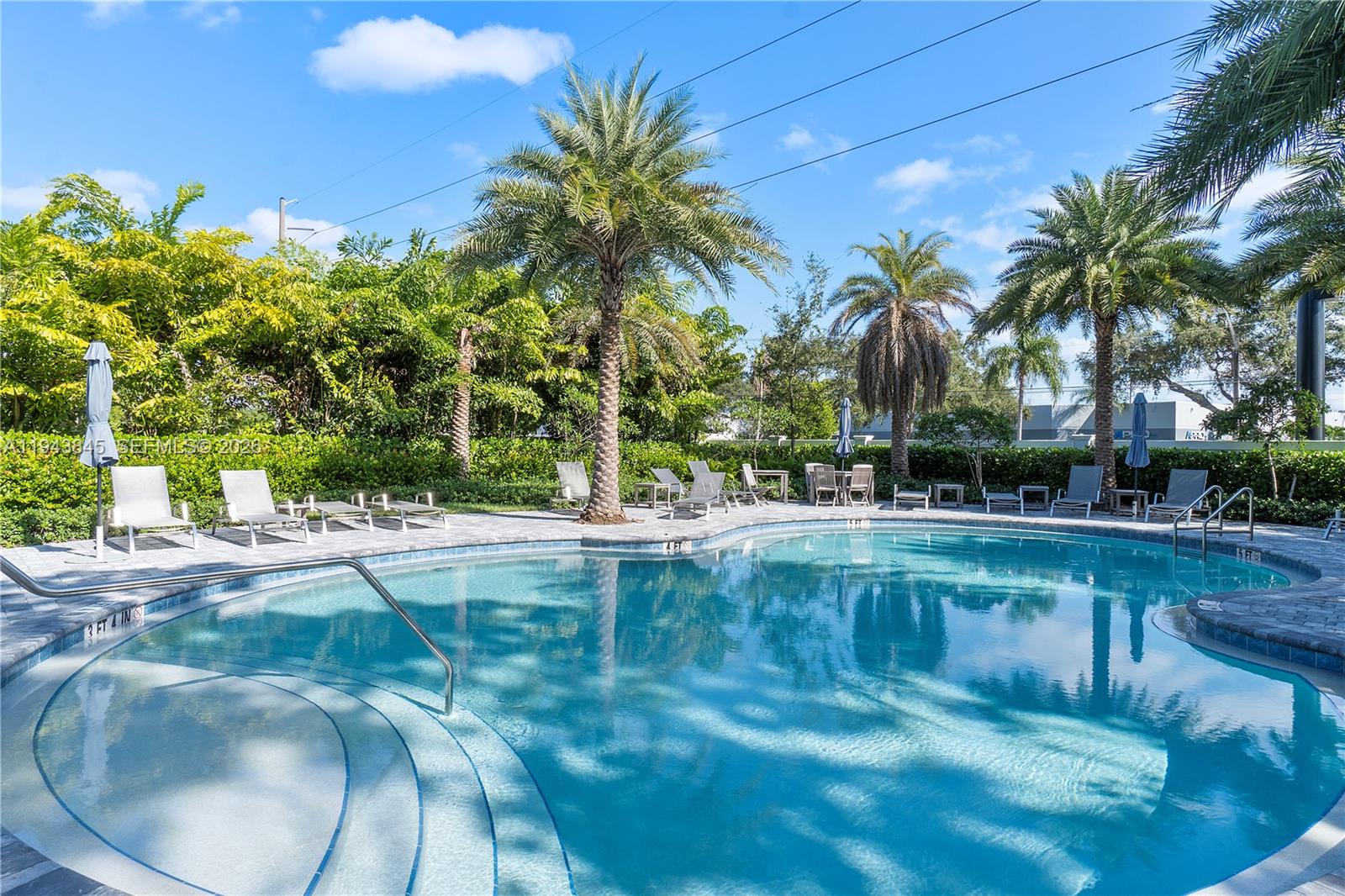 1827 Sandpiper Pointe Place Deerfield Beach, FL 33442 - Photo 43 of 48 a view of a swimming pool and a yard