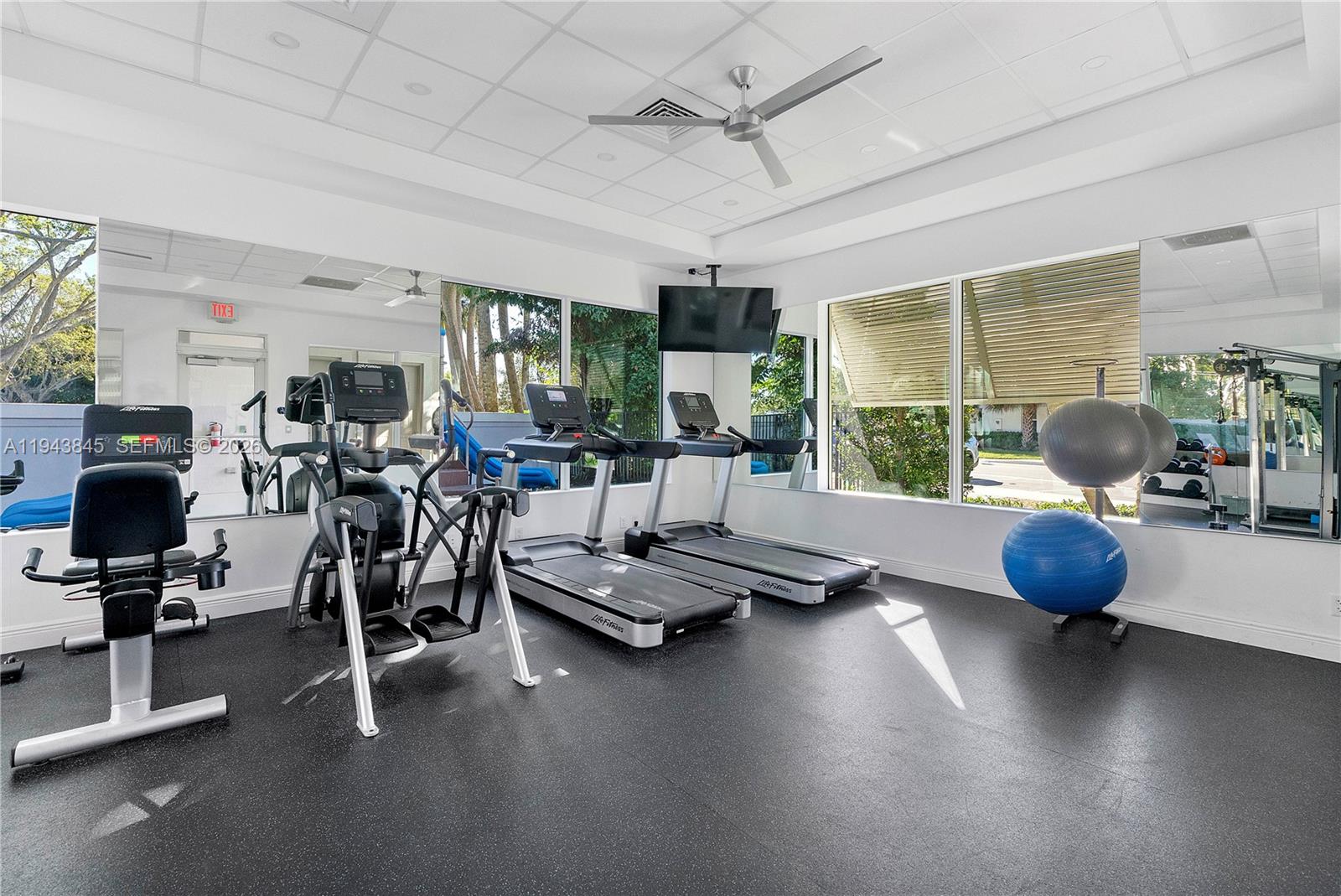 1827 Sandpiper Pointe Place Deerfield Beach, FL 33442 - Photo 47 of 48 a room with gym equipment and windows