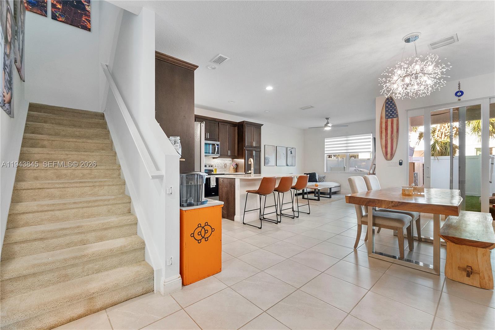 1827 Sandpiper Pointe Place Deerfield Beach, FL 33442 - Photo 7 of 48 a living room with furniture and a chandelier