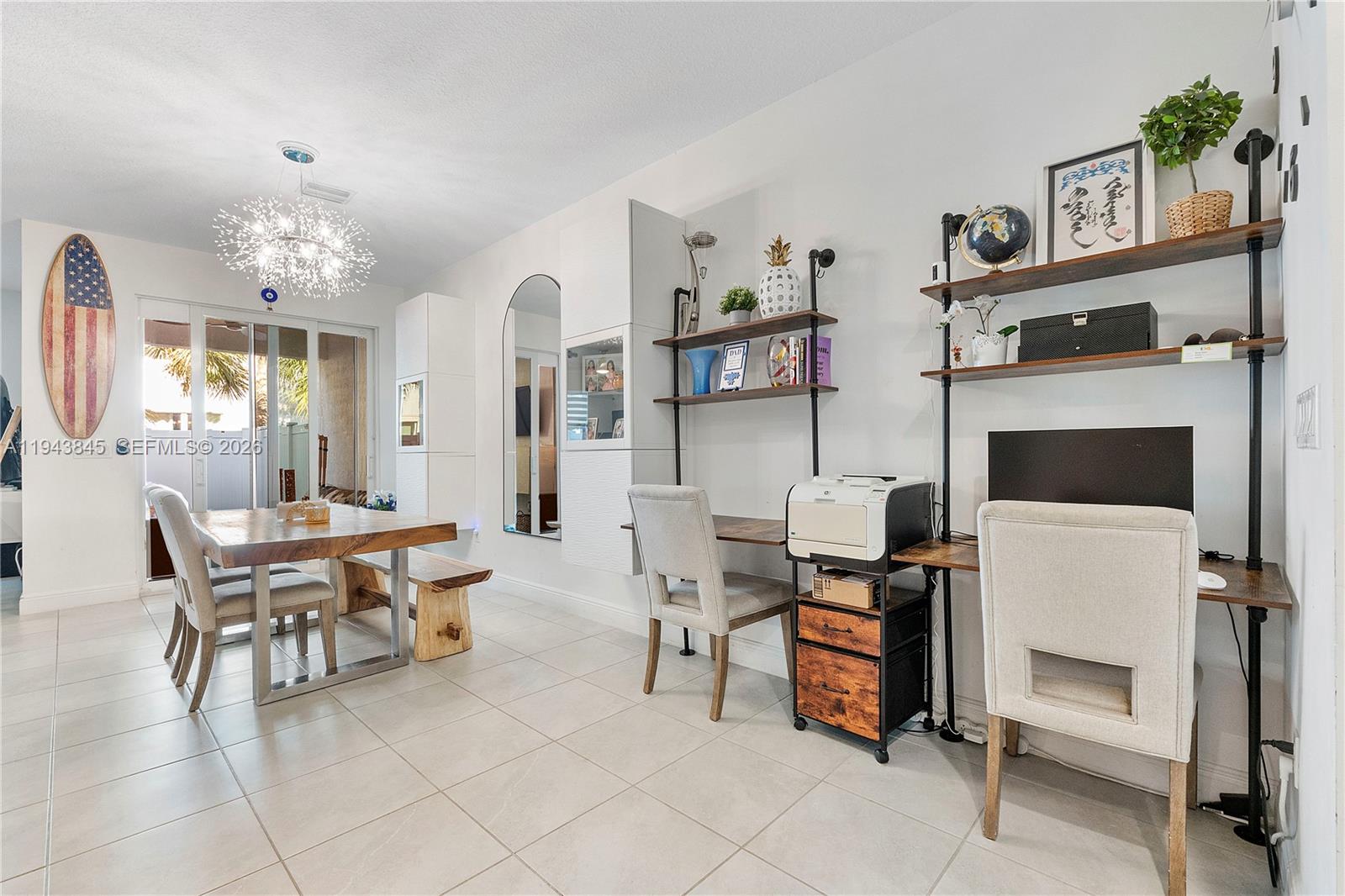 1827 Sandpiper Pointe Place Deerfield Beach, FL 33442 - Photo 8 of 48 a living room with furniture a fireplace and a chandelier