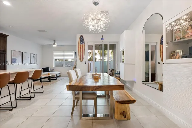 a view of a dining room and kitchen with furniture and a large window