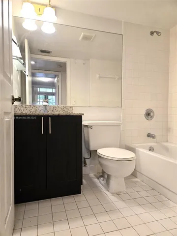 a bathroom with a sink a toilet and bathtub