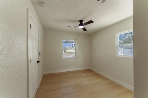 a view of room with a ceiling fan and window