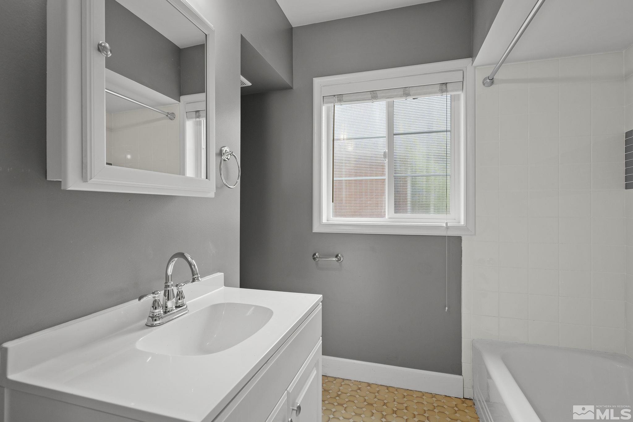701 Stewart Street Reno, NV 89502 - Photo 15 of 40 a bathroom with a sink and a window