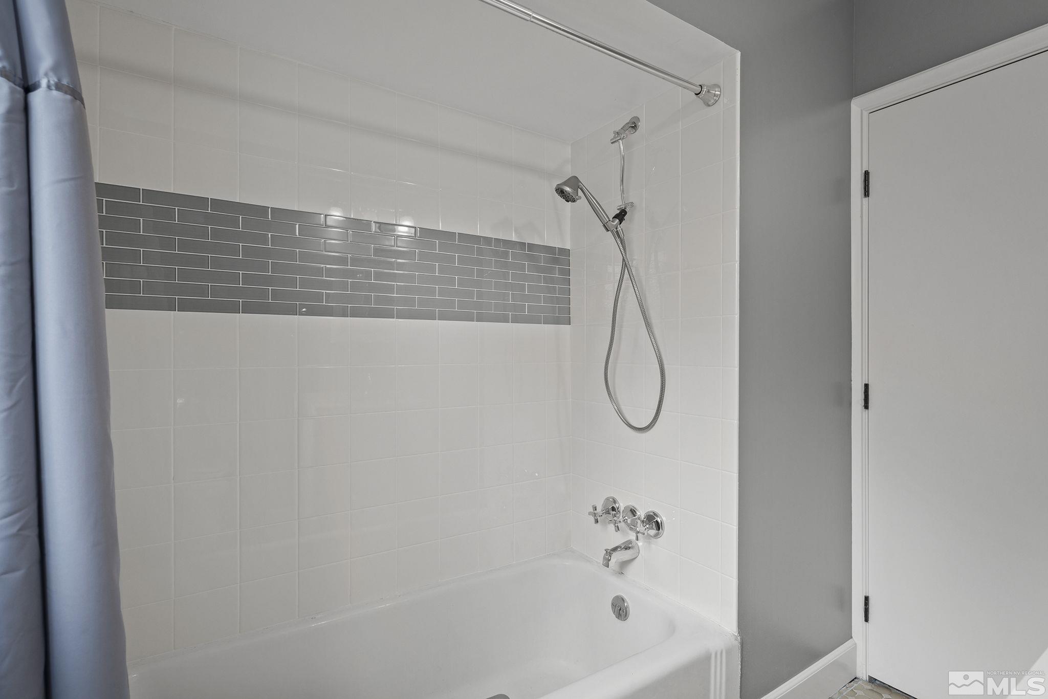 701 Stewart Street Reno, NV 89502 - Photo 16 of 40 a bathroom with a bath tub with a shower