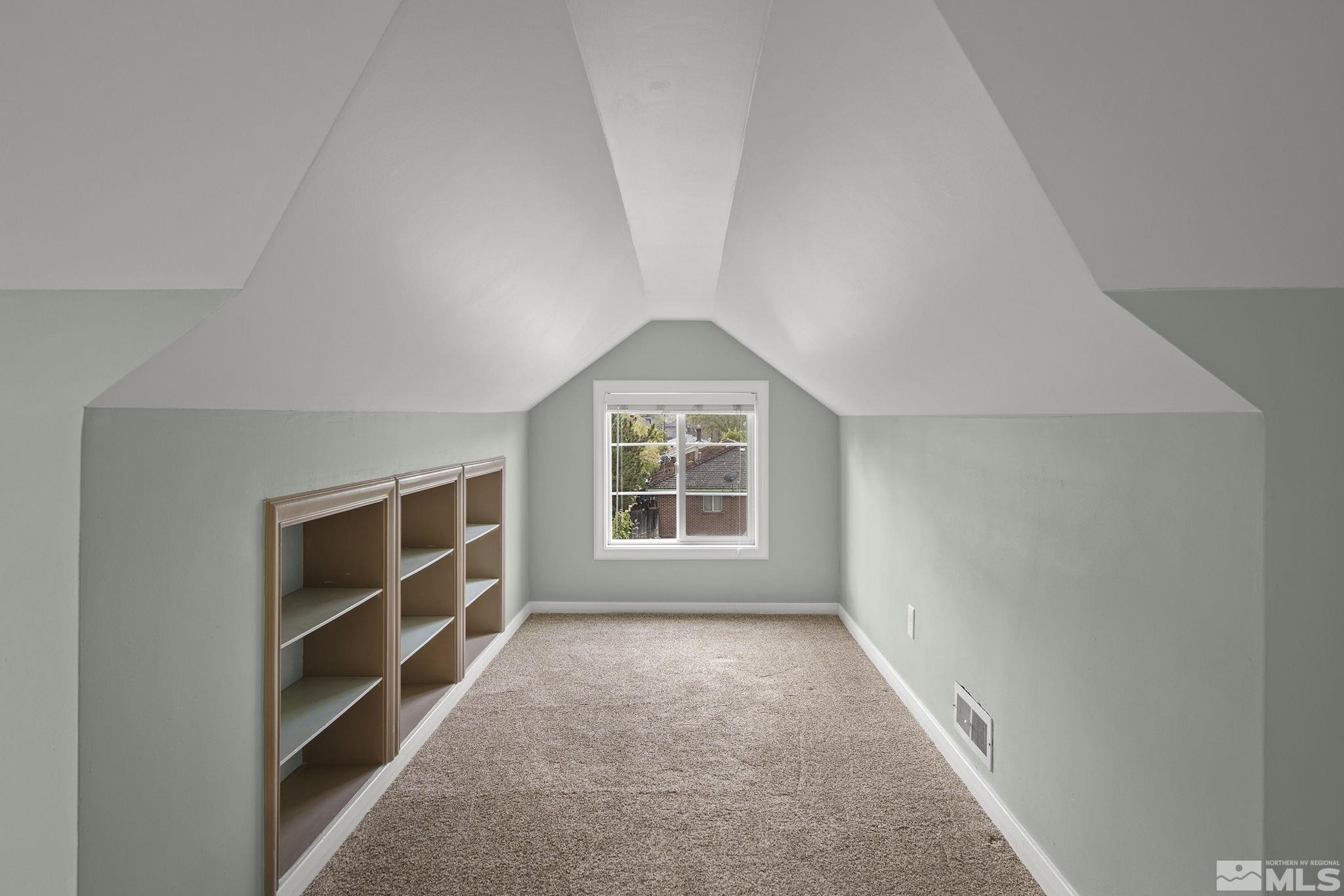 701 Stewart Street Reno, NV 89502 - Photo 19 of 40 a view of an empty room with a window and cabinet