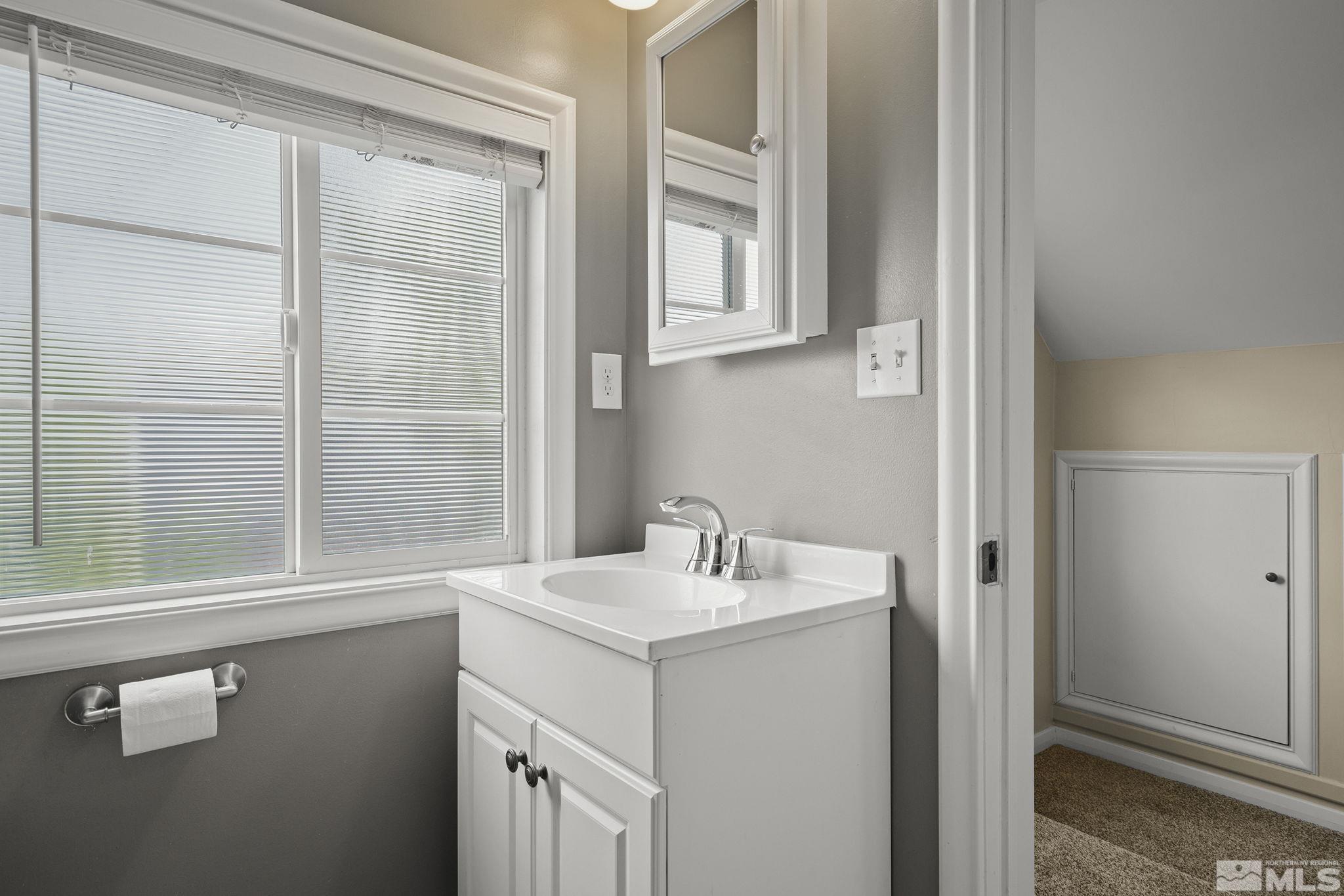 701 Stewart Street Reno, NV 89502 - Photo 21 of 40 a bathroom with a sink and a mirror