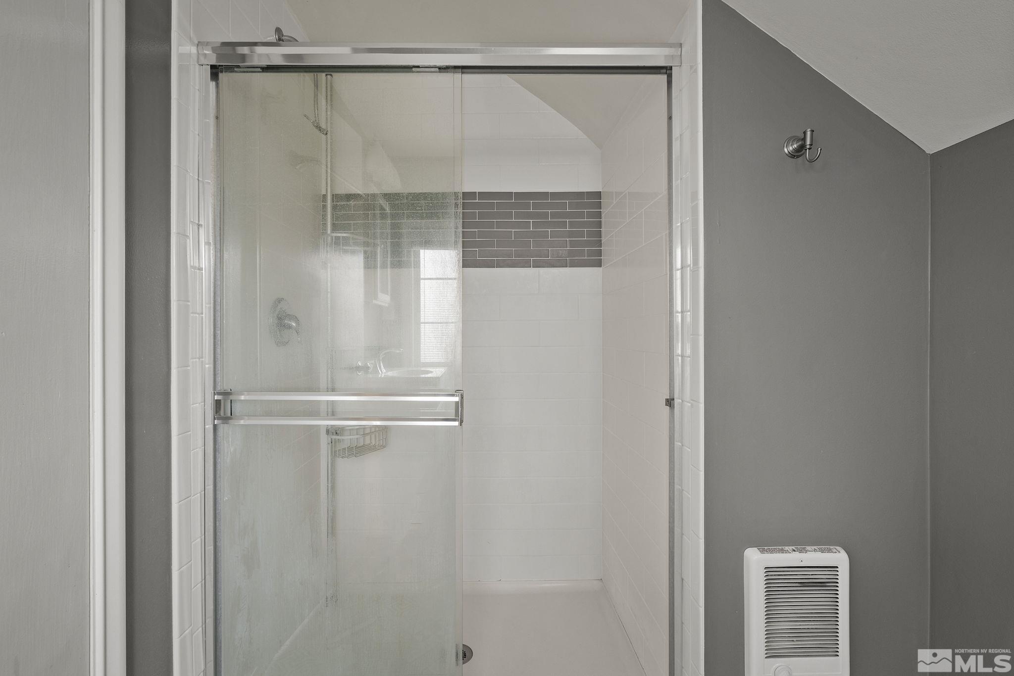701 Stewart Street Reno, NV 89502 - Photo 22 of 40 a bathroom with a glass shower door