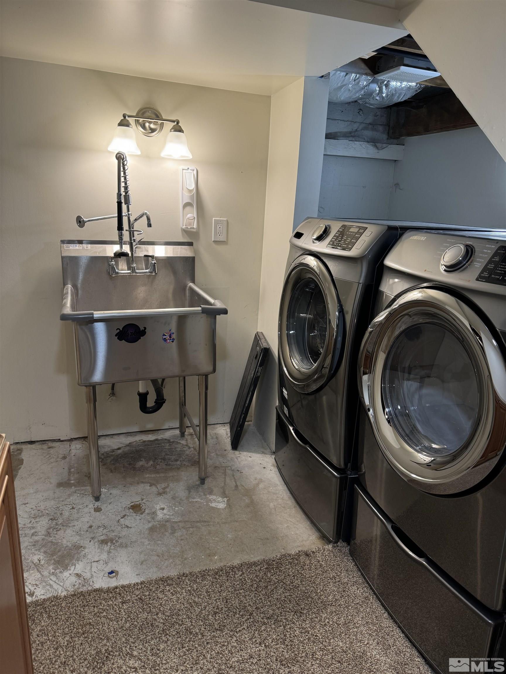 701 Stewart Street Reno, NV 89502 - Photo 35 of 40 a utility room with sink dryer and washer