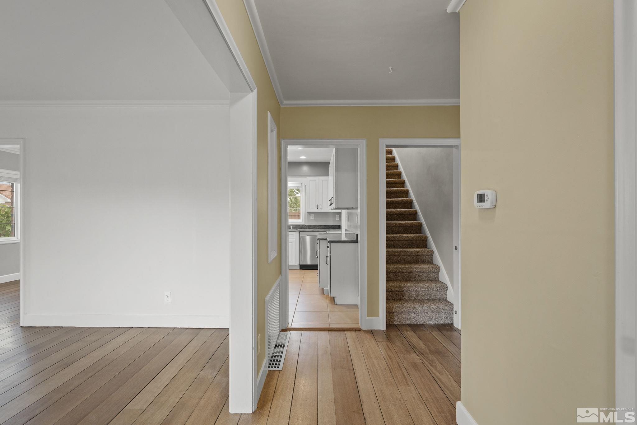 701 Stewart Street Reno, NV 89502 - Photo 4 of 40 a view of a hallway with wooden floor and staircase
