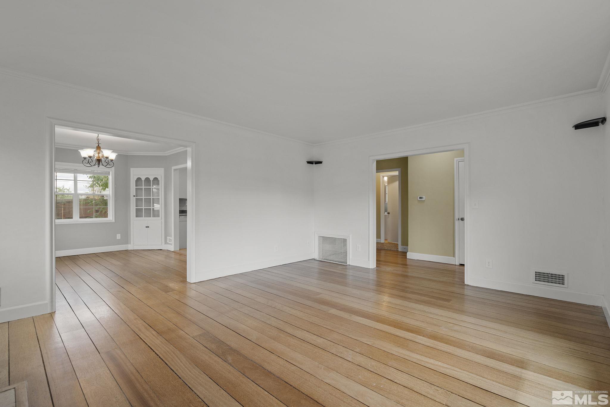 701 Stewart Street Reno, NV 89502 - Photo 7 of 40 a view of an empty room with wooden floor and a window
