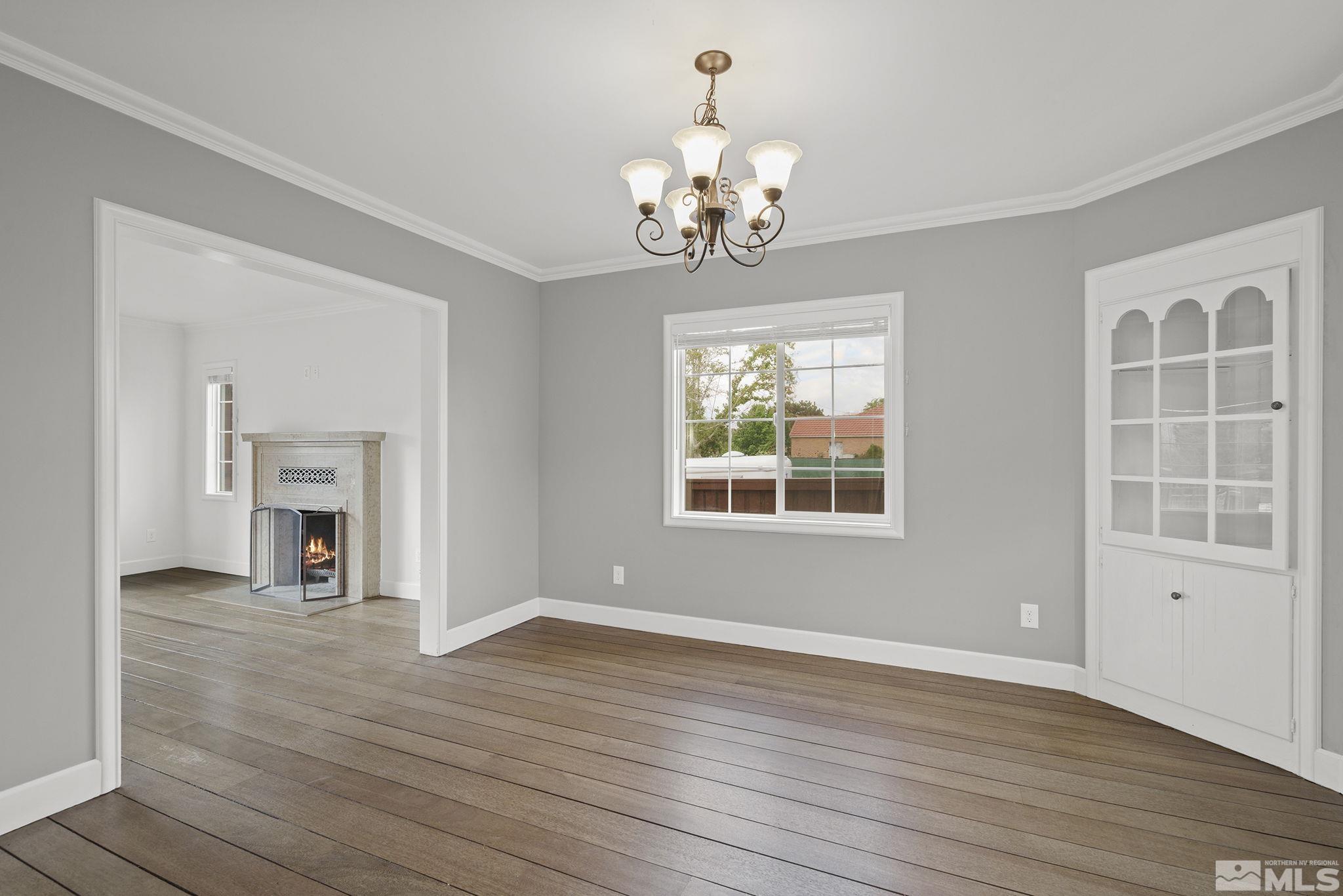 701 Stewart Street Reno, NV 89502 - Photo 9 of 40 a view of an empty room with a window and wooden floor
