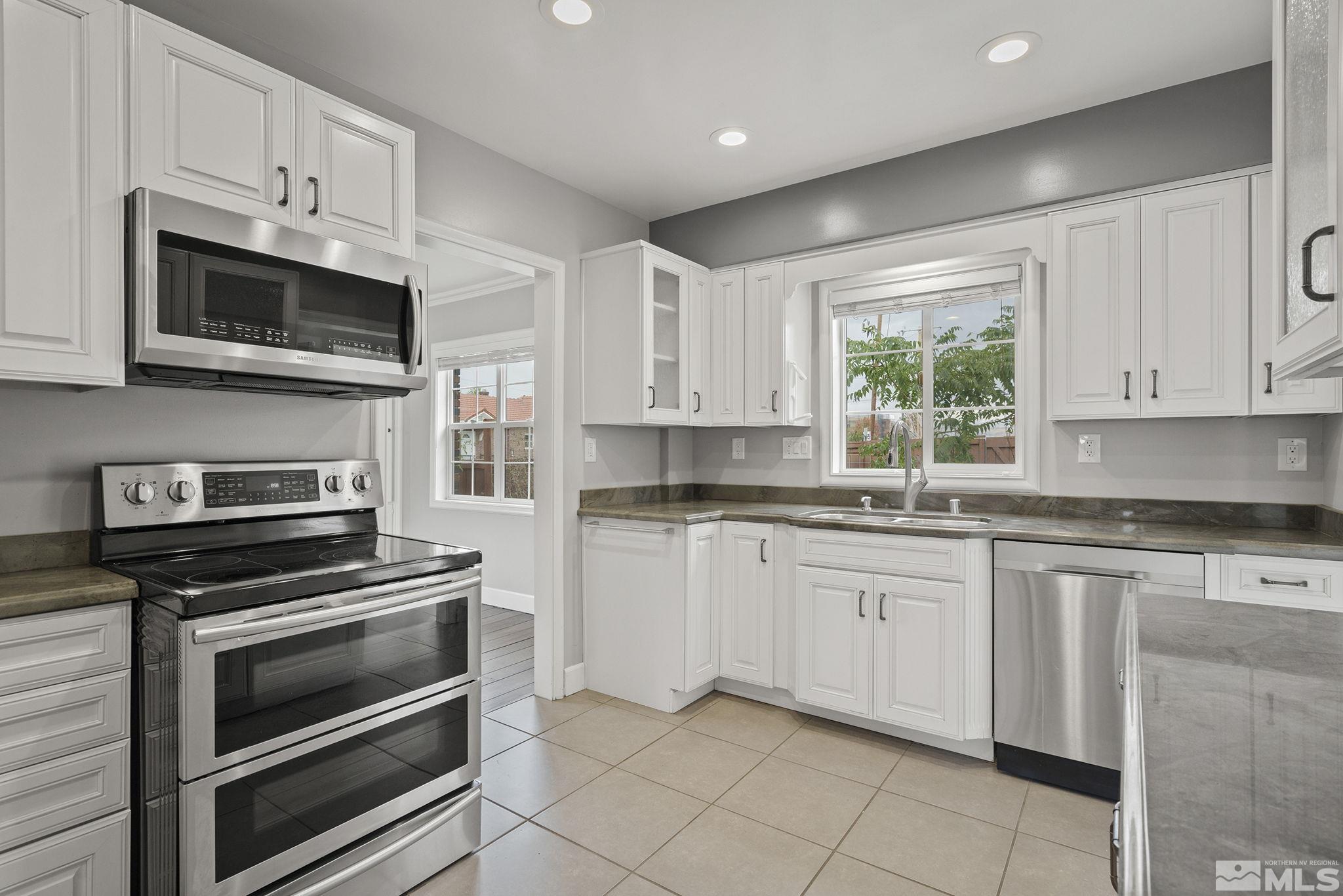 701 Stewart Street Reno, NV 89502 - Photo 10 of 40 a kitchen with cabinets stainless steel appliances and a window