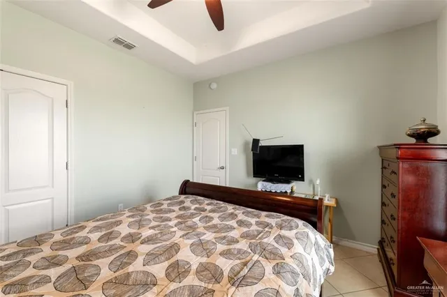 a bedroom with a bed and flat screen tv