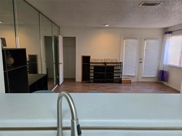 a view of a living room and kitchen with furniture wooden floor and a kitchen