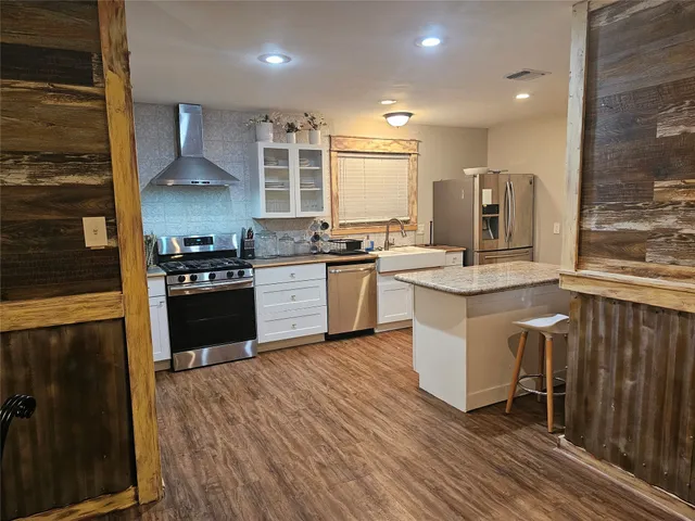 a view of a hallway with furniture and stairs