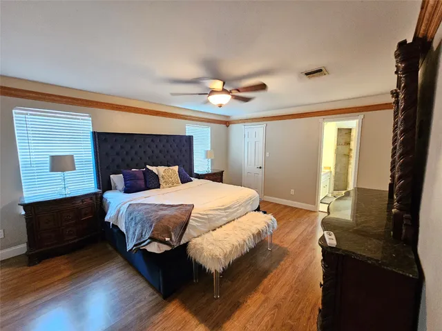 a bedroom with a bed dresser and a window