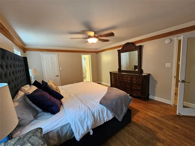 a bathroom with a granite countertop sink a toilet and a mirror