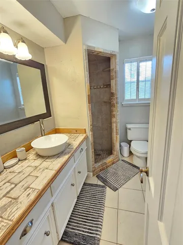 a bathroom with a sink a toilet and mirror