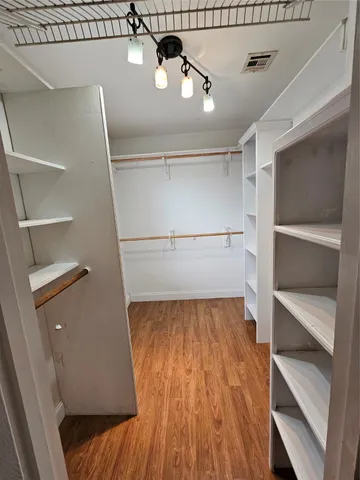 a spacious bedroom with a bed and a ceiling fan