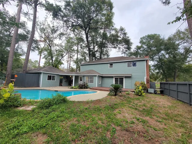 a swimming pool with outdoor seating and yard