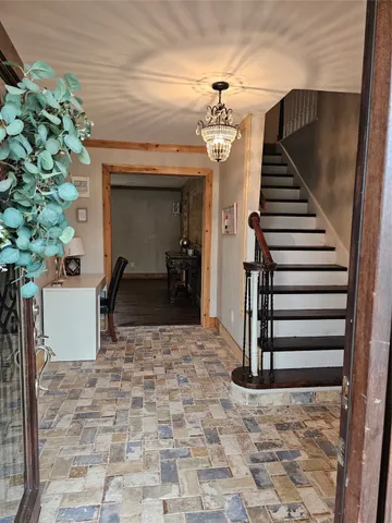 a view of hall way with furniture