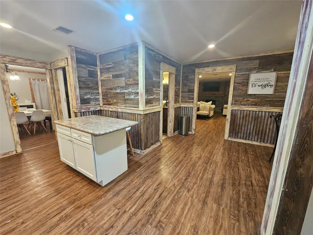 a kitchen with a sink and wooden floor