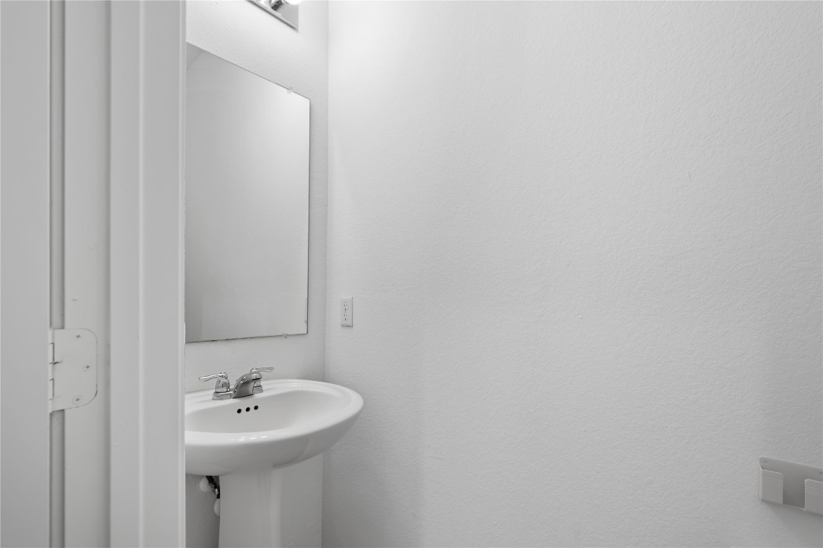 148 Rowdy Yates Way Jarrell, TX 76537 - Photo 19 of 39 a bathroom with a sink and mirror