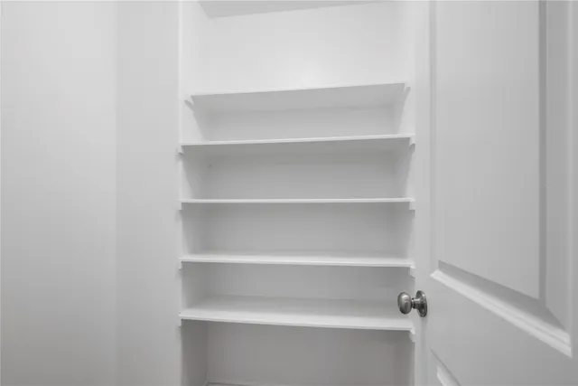 an empty room with windows and entrance