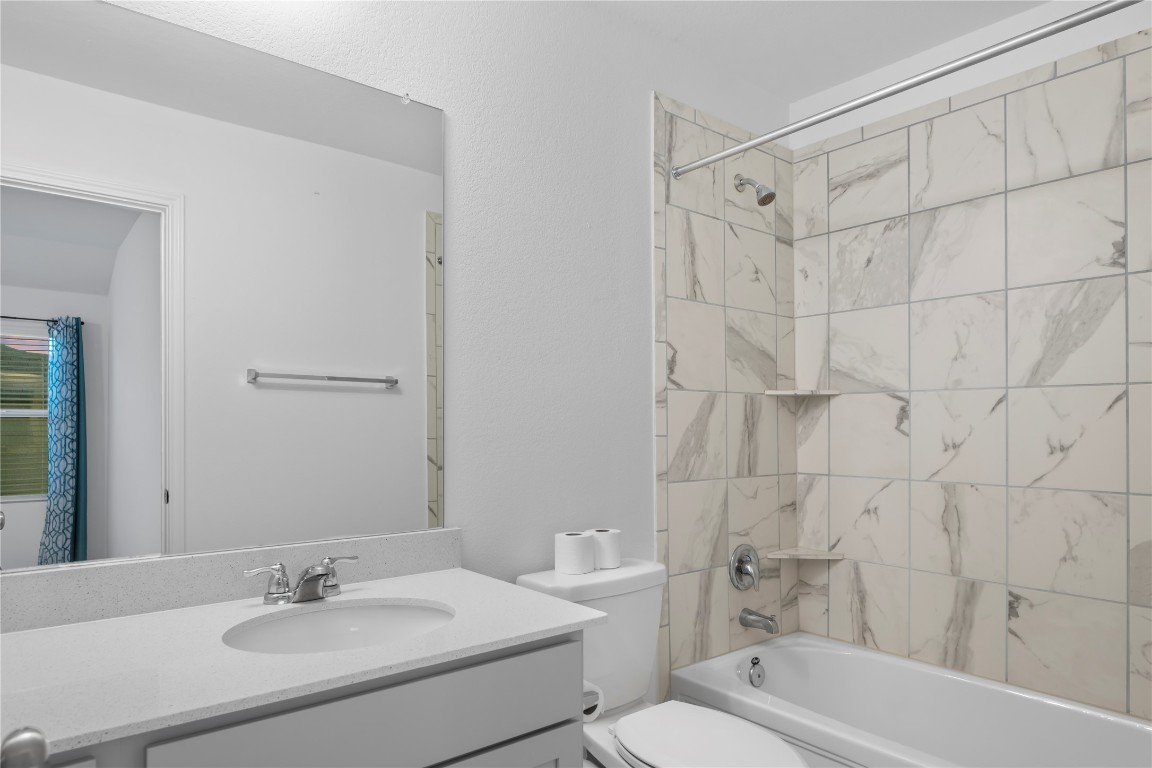 148 Rowdy Yates Way Jarrell, TX 76537 - Photo 24 of 39 a bathroom with a sink toilet and shower