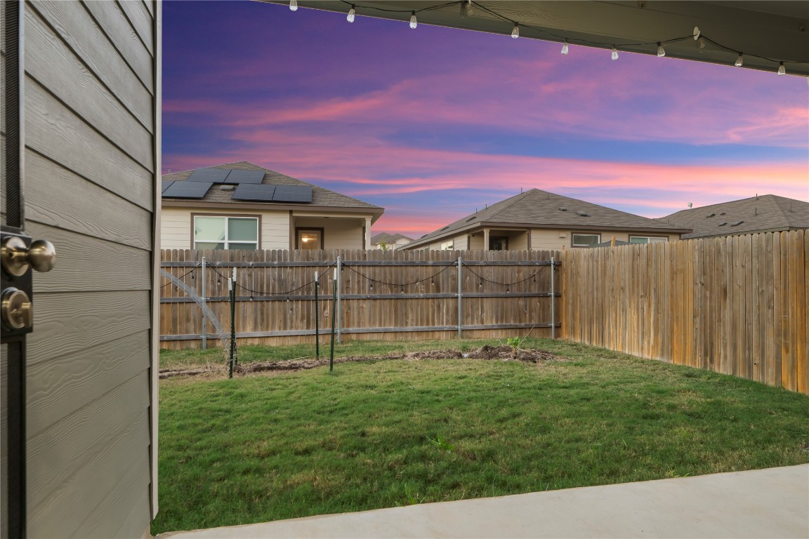 148 Rowdy Yates Way Jarrell, TX 76537 - Photo 32 of 39 a backyard of a house with lots of green space