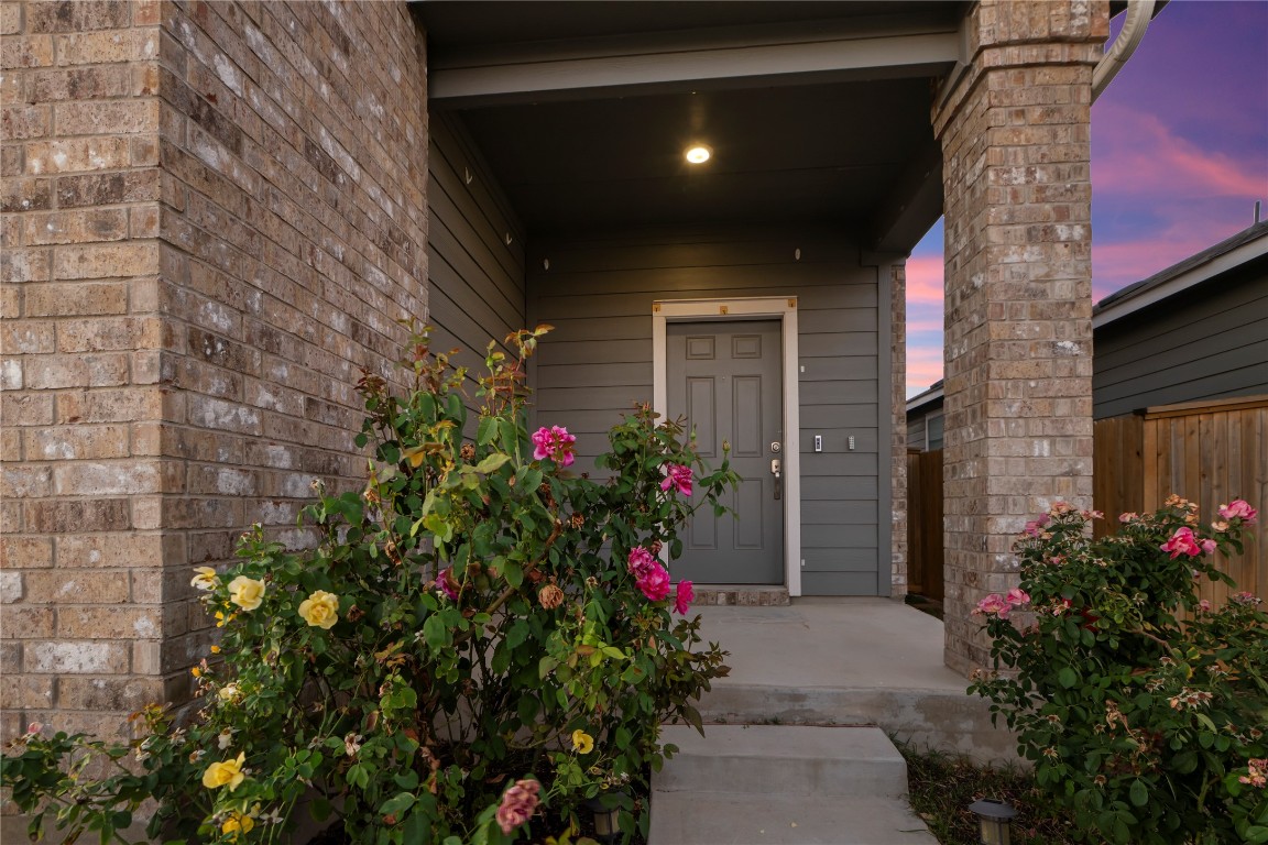 148 Rowdy Yates Way Jarrell, TX 76537 - Photo 4 of 39 a potted plant sitting in front of a house